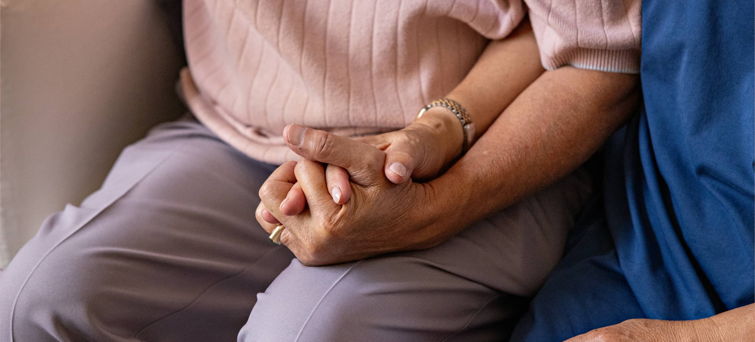 Two people holding each other's hand.