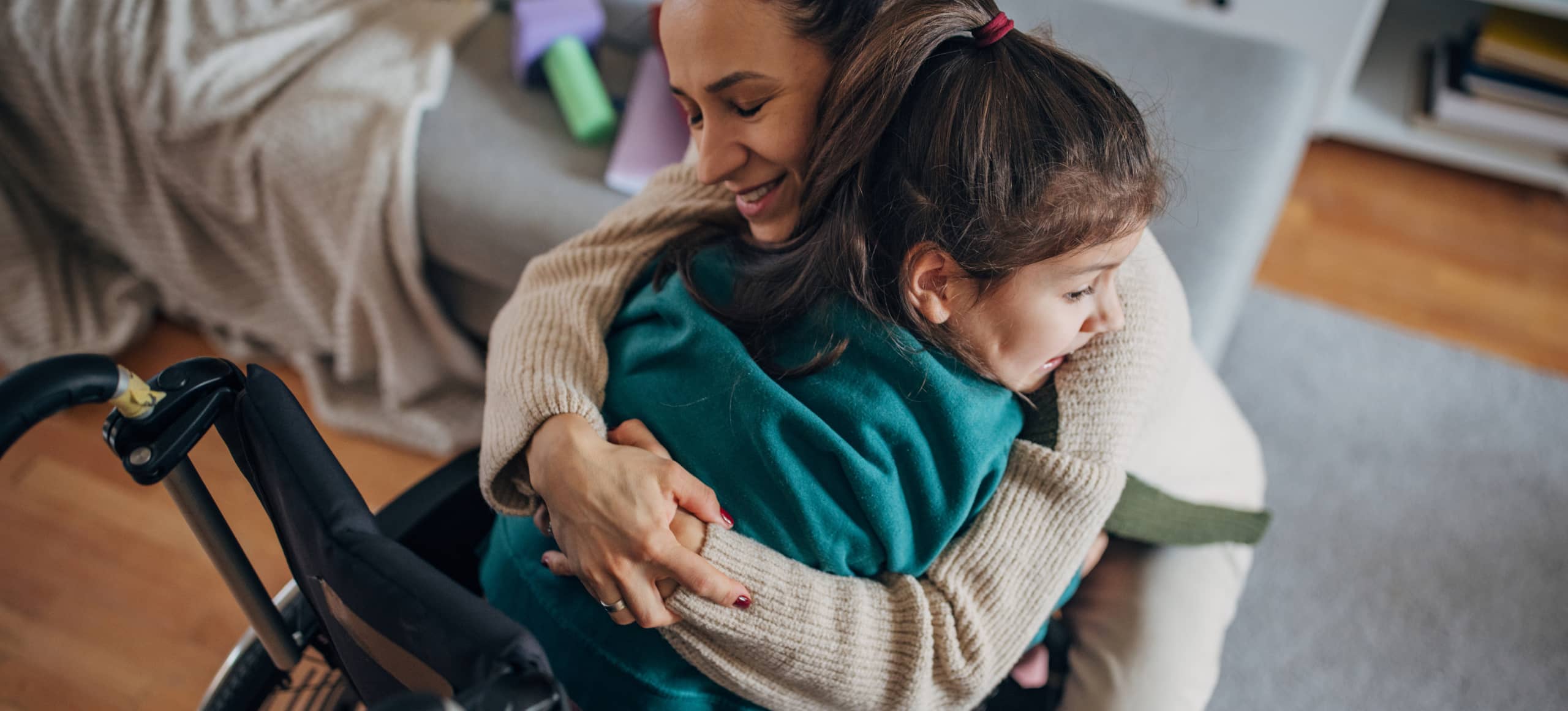 A parent wrapping their arms around their child.