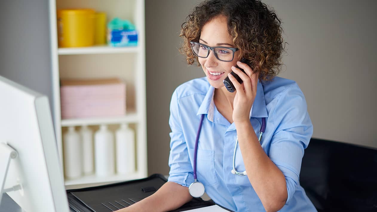A health care provider on their cell phone in the office
