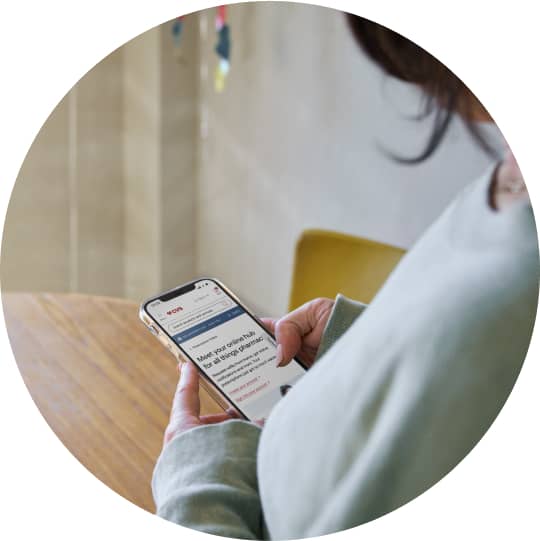 A cell phone screen seen over a person's shoulder.