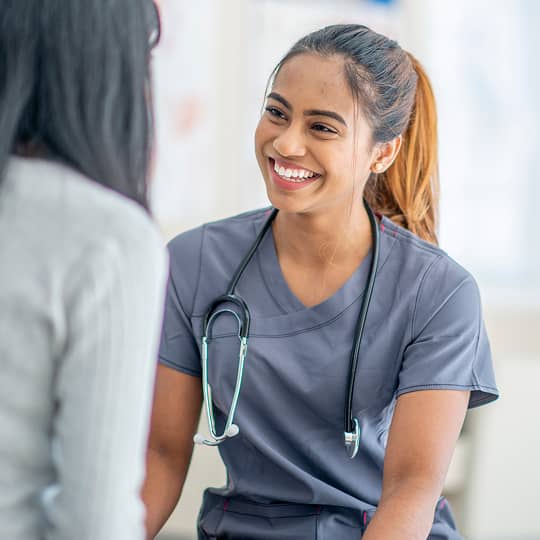 A health care provider smiling at a patient