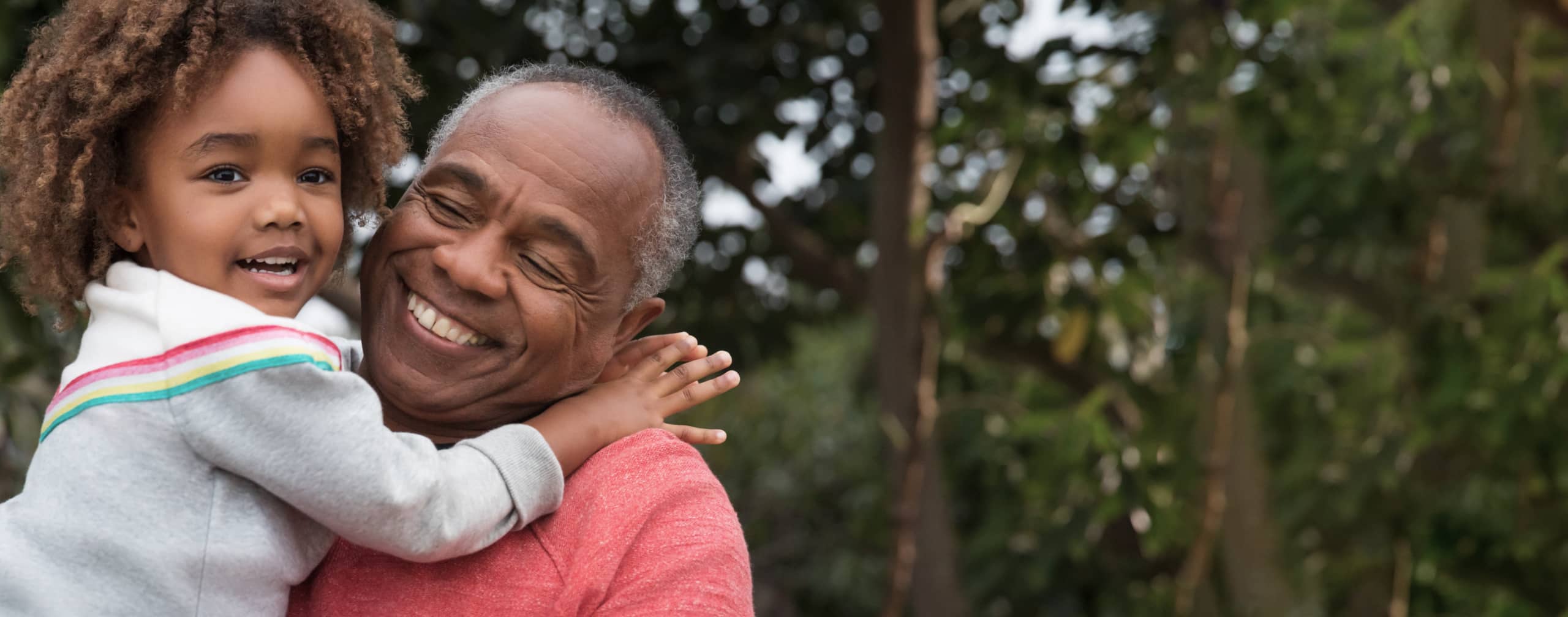 A grandparent holds their grandchild