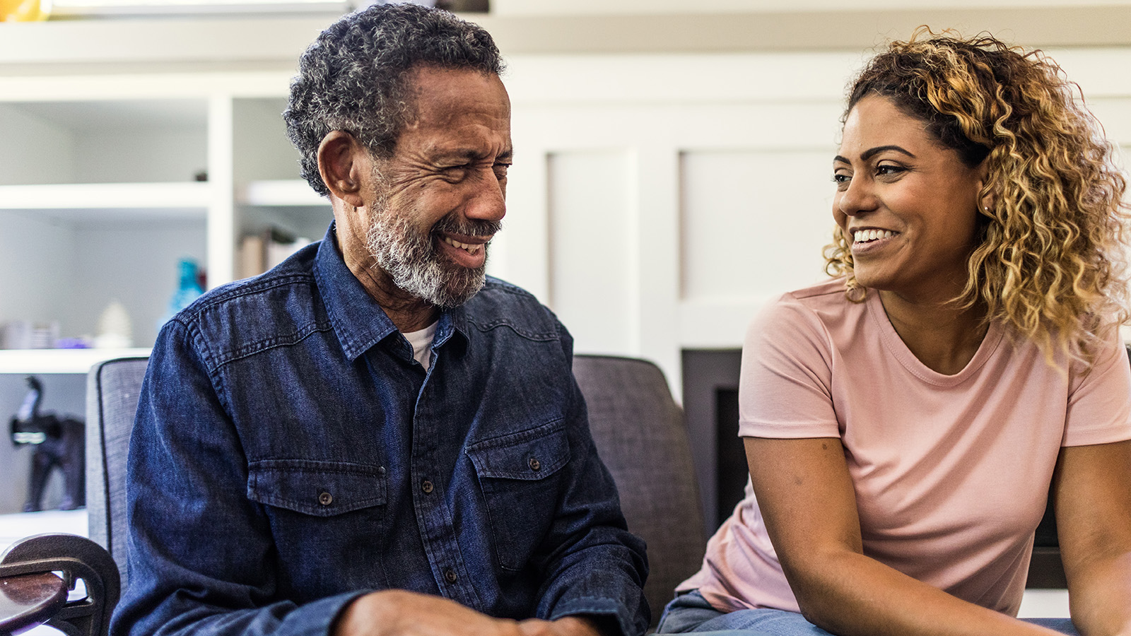 Two people sitting together, engaged in conversation.