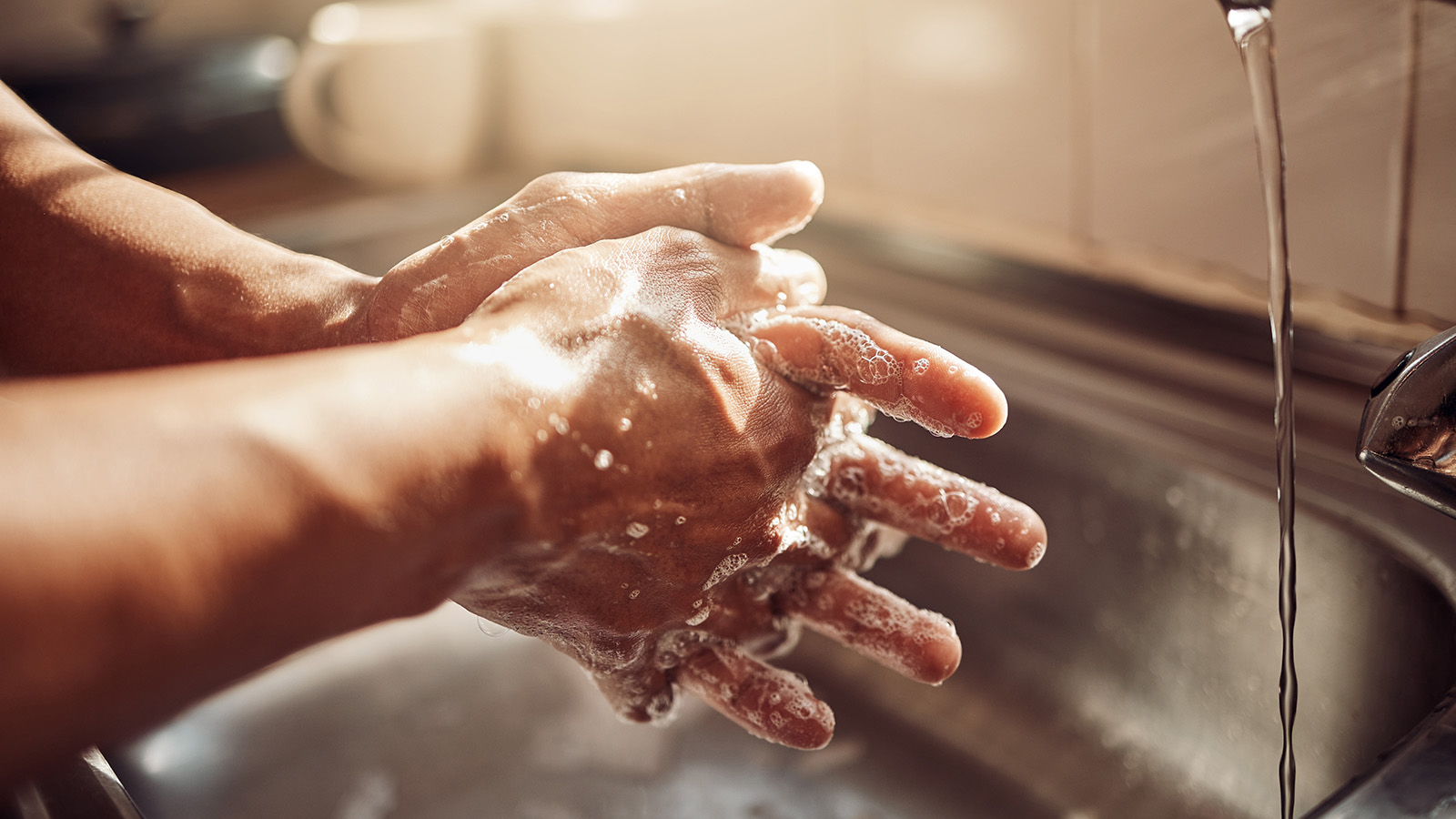 Hands washing with soap under running water