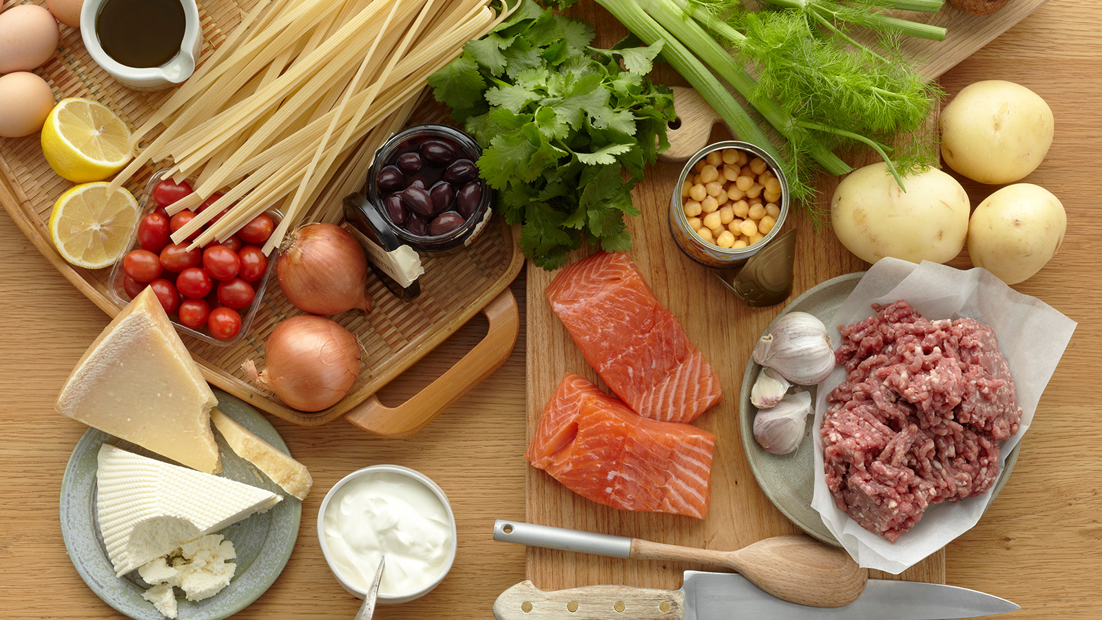 A variety of fresh ingredients arranged on a wooden surface