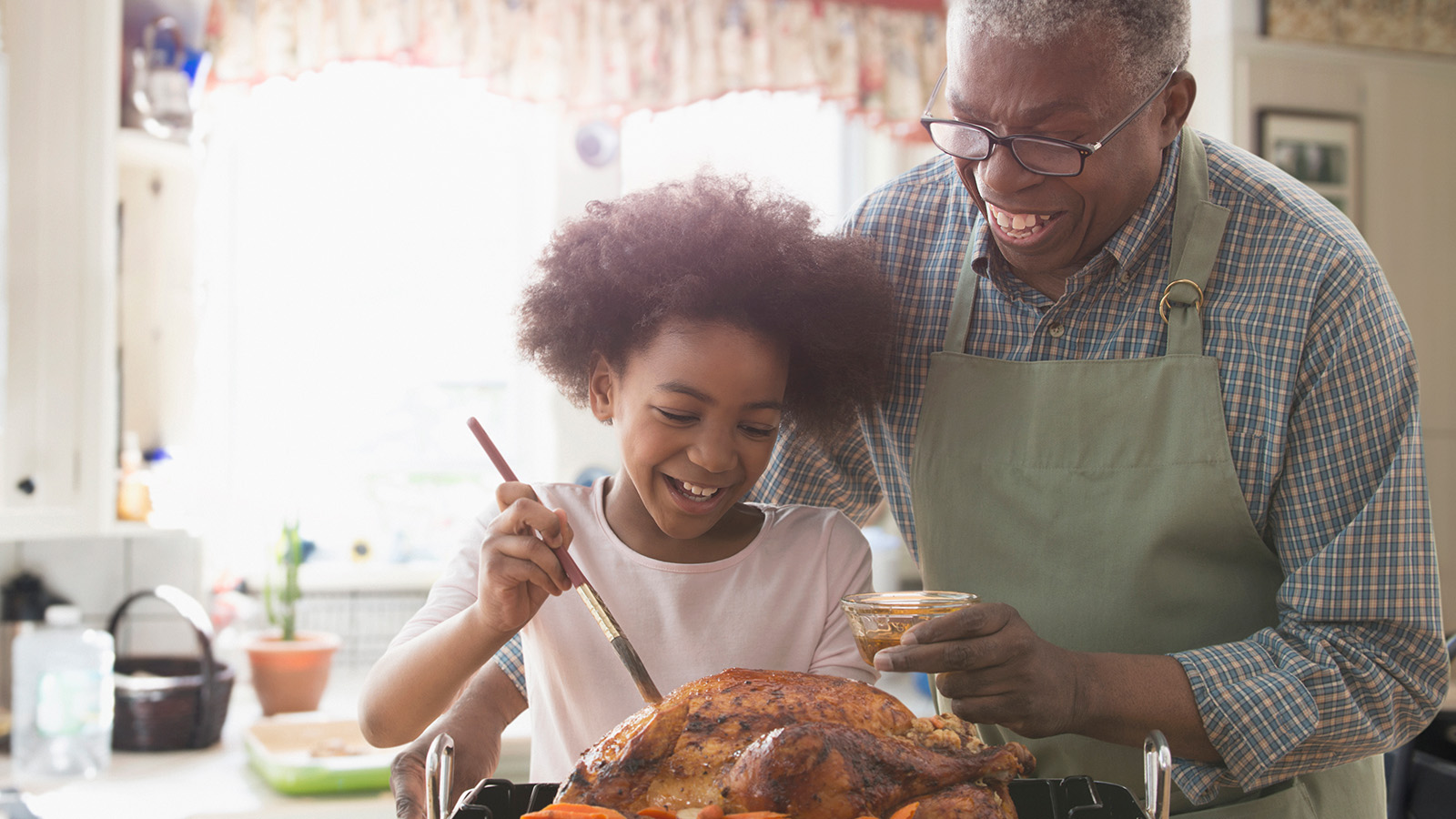 A grandparent and child cooking together in a kitchen