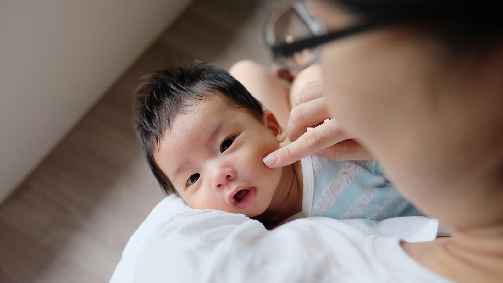 An overhead view of a child being held by an adult