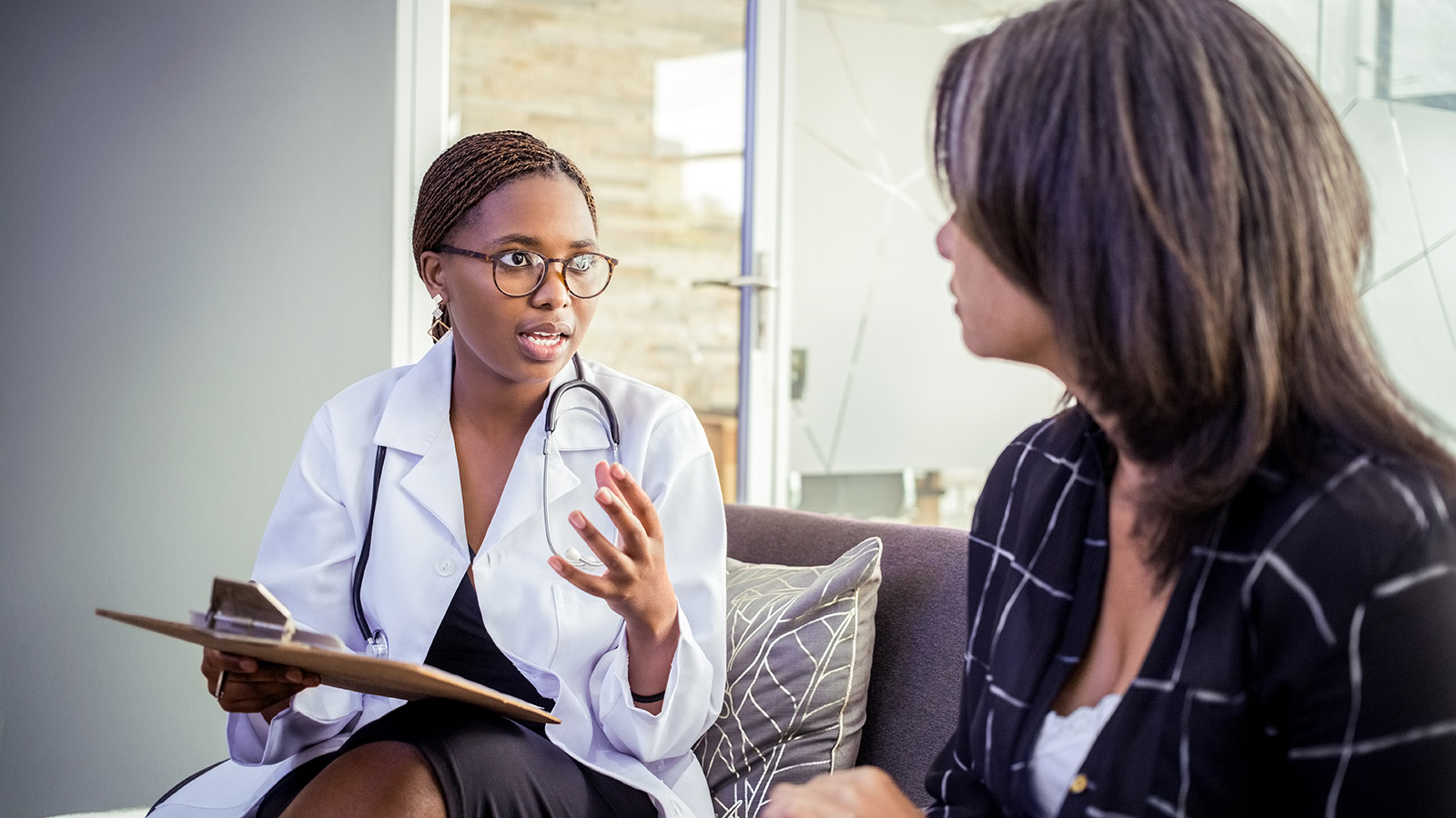 A doctor is explaining something to a patient during a consultation