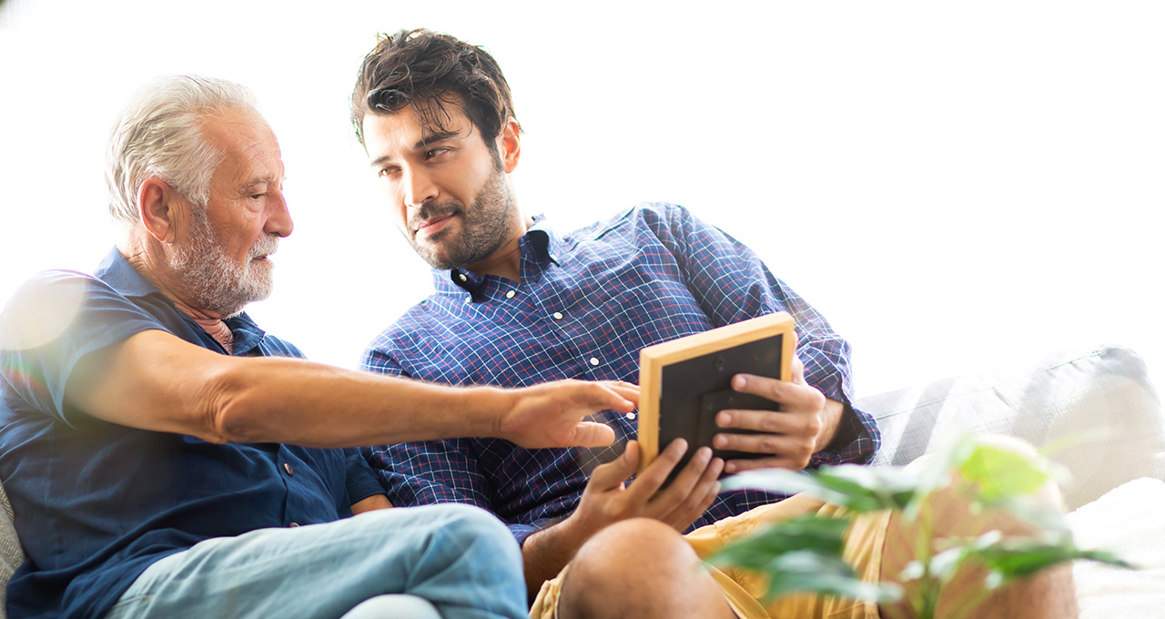 Two men discussing something on a tablet together